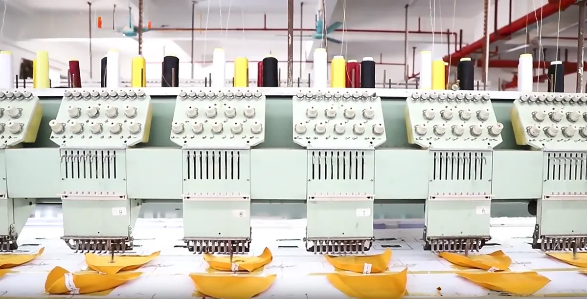 Multi-head embroidery machines stitching hat panels